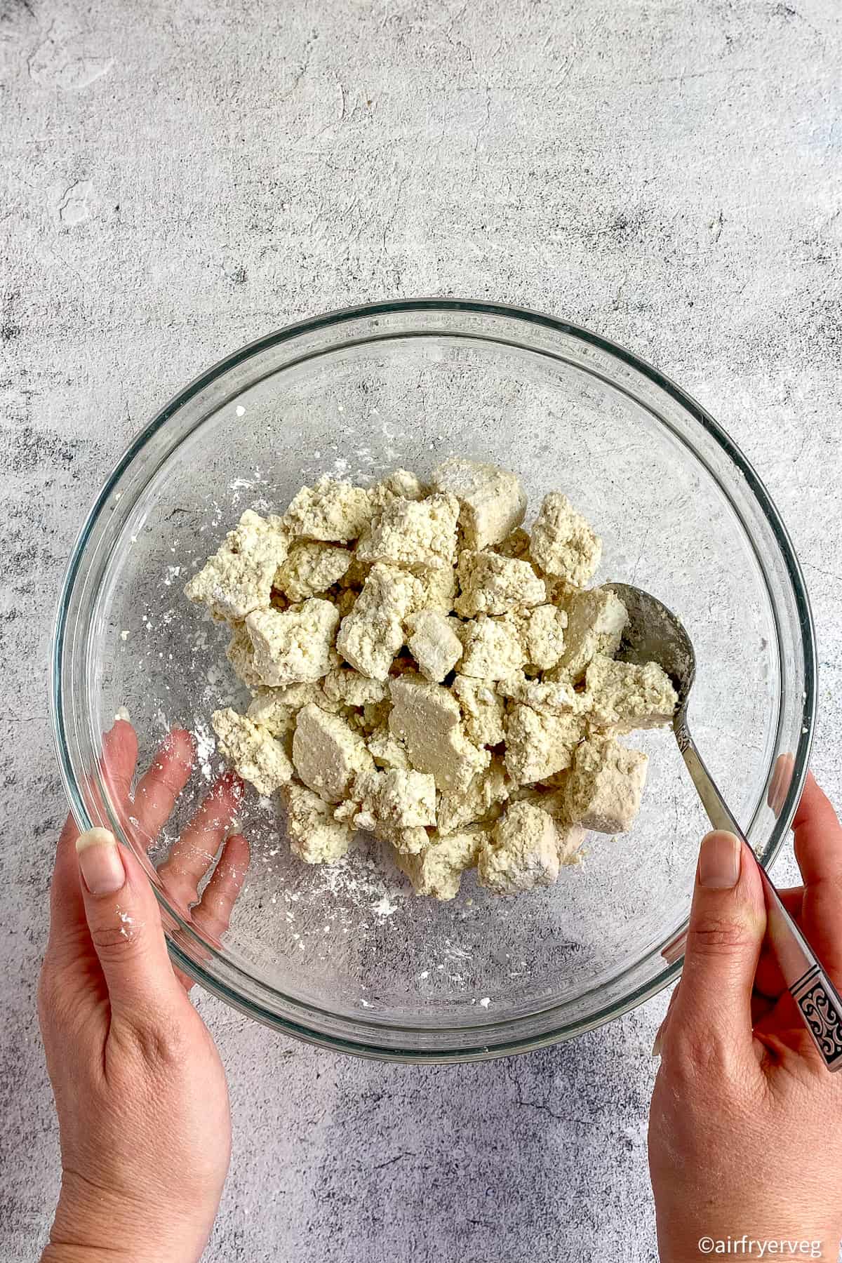 Tofu mixed with cornstarch in a bowl.