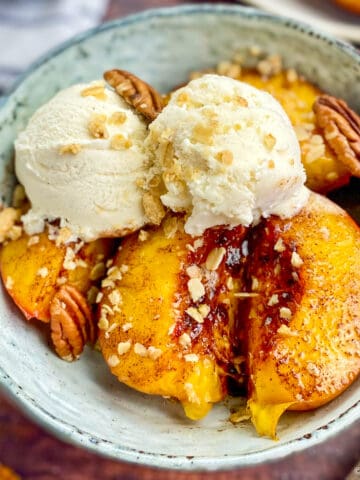 Close-up of air fryer nectarines in a bowl with ice cream.