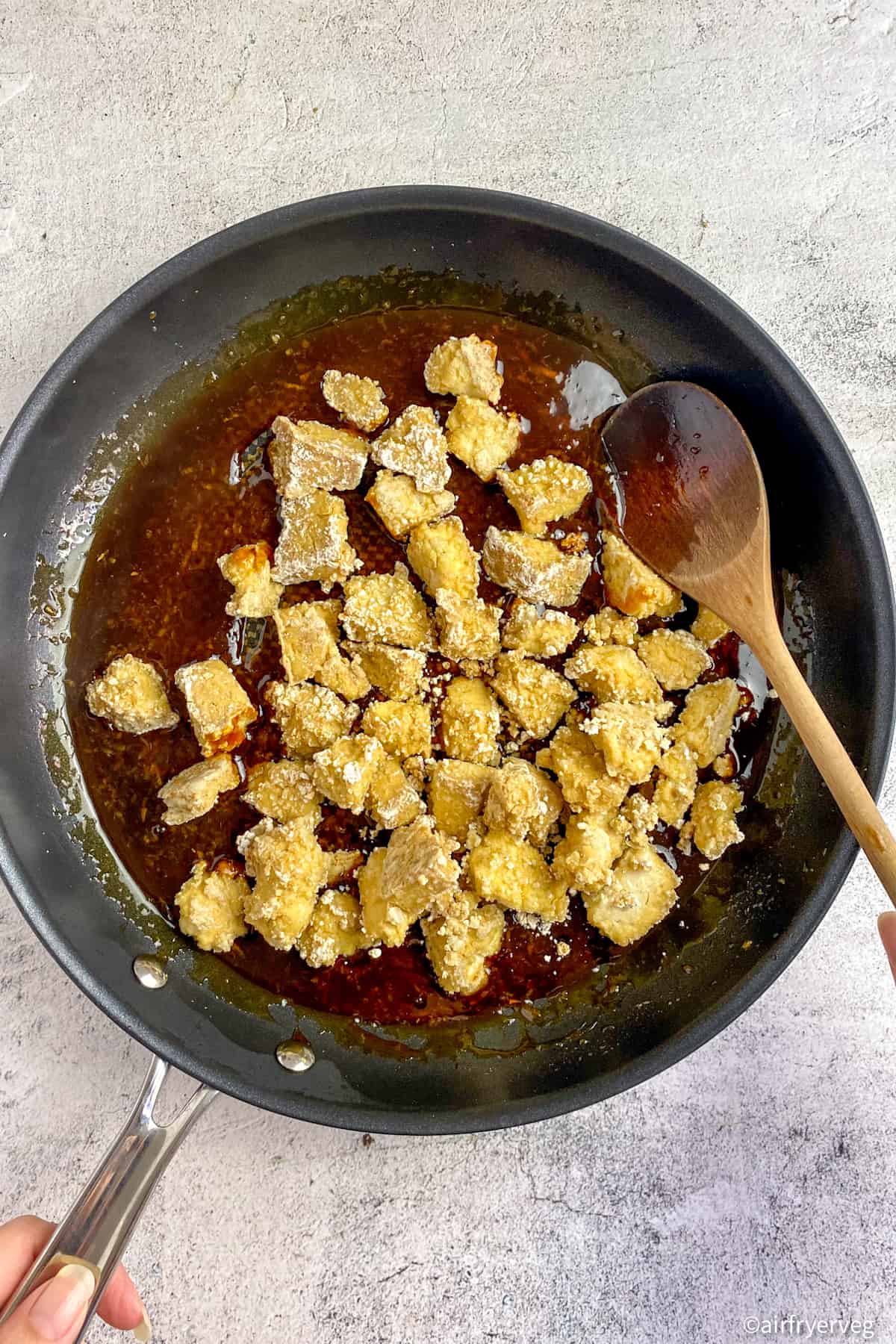 Air fried teriyaki tofu in a skillet with sauce.