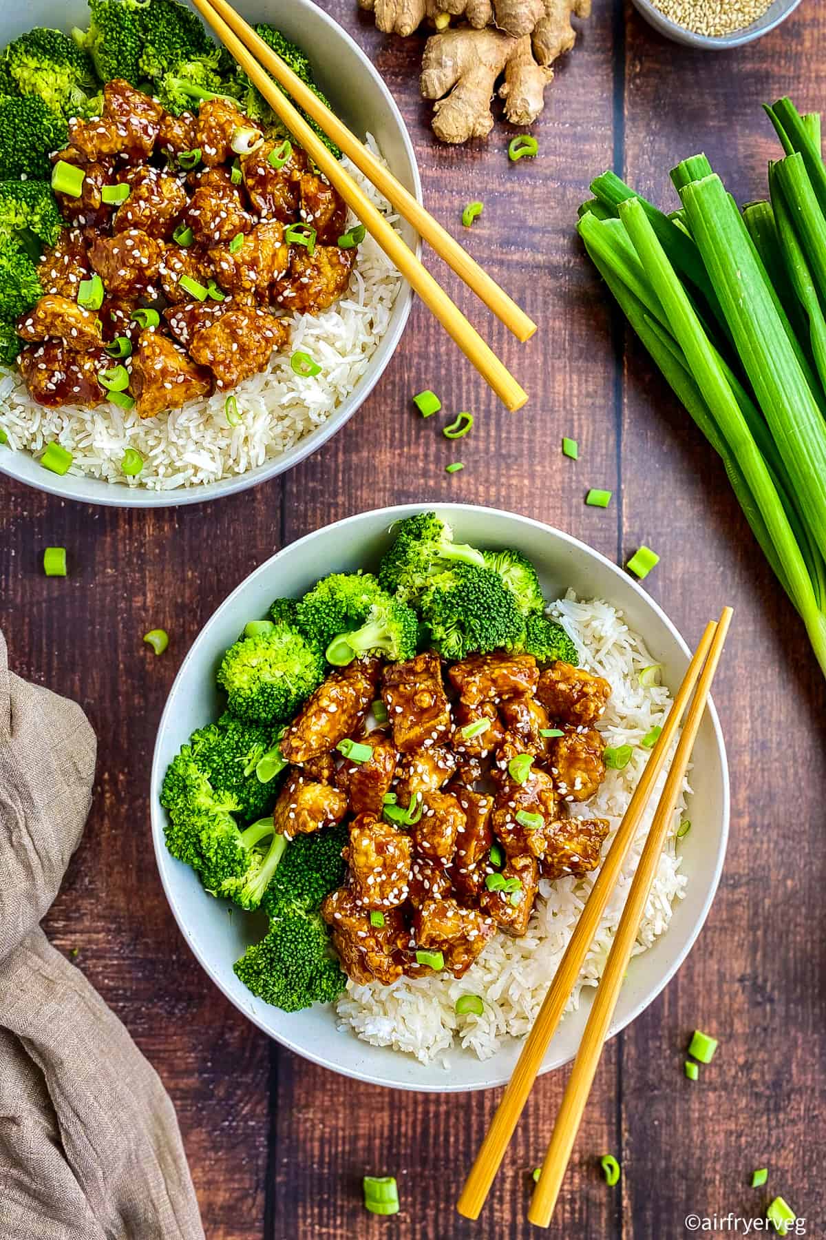 Air fryer teriyaki tofu in two bowls with broccoli.