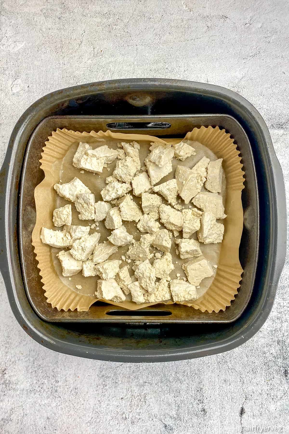 Uncooked tofu in air fryer.