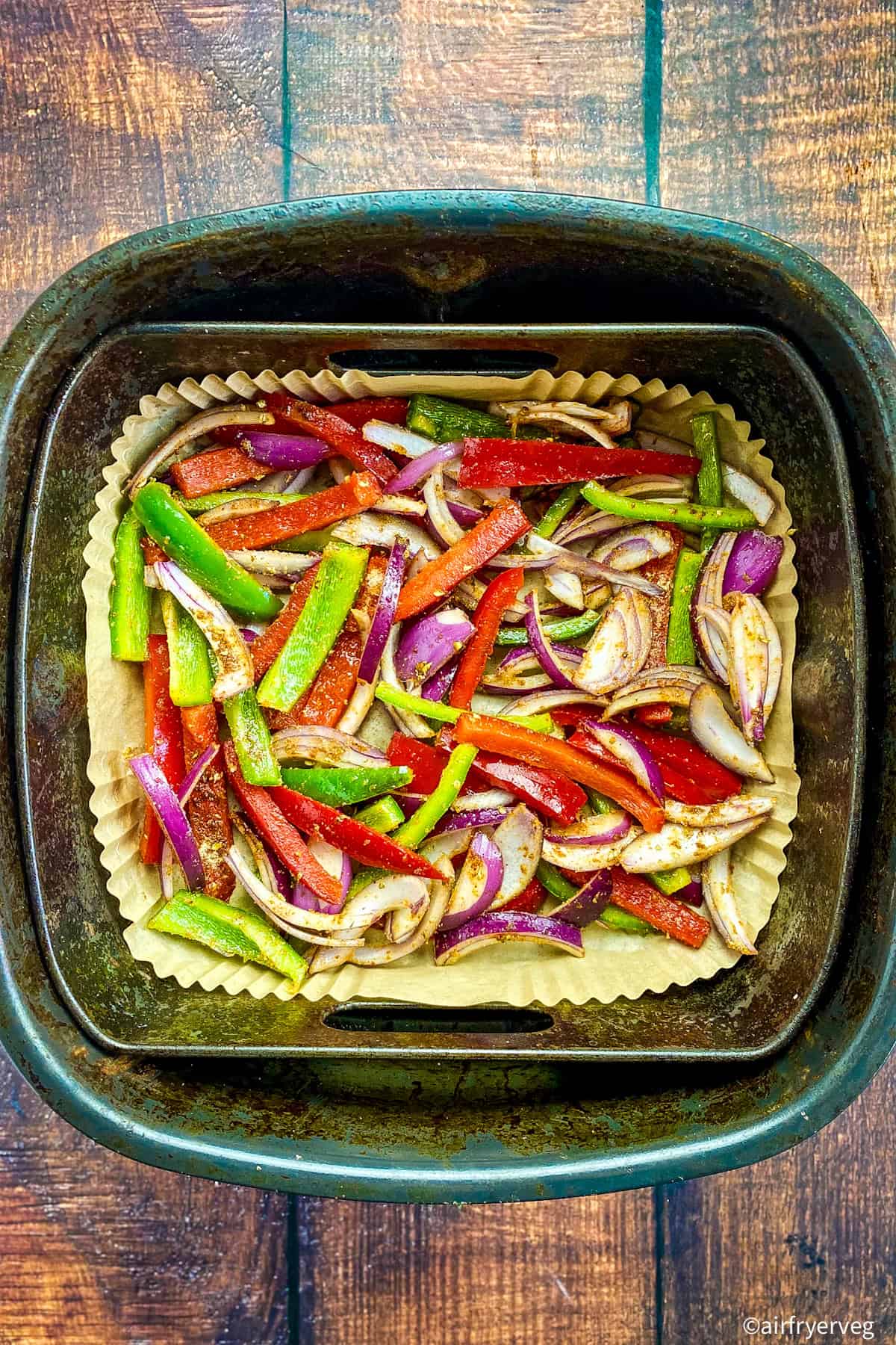 Peppers and onions in an air fryer.